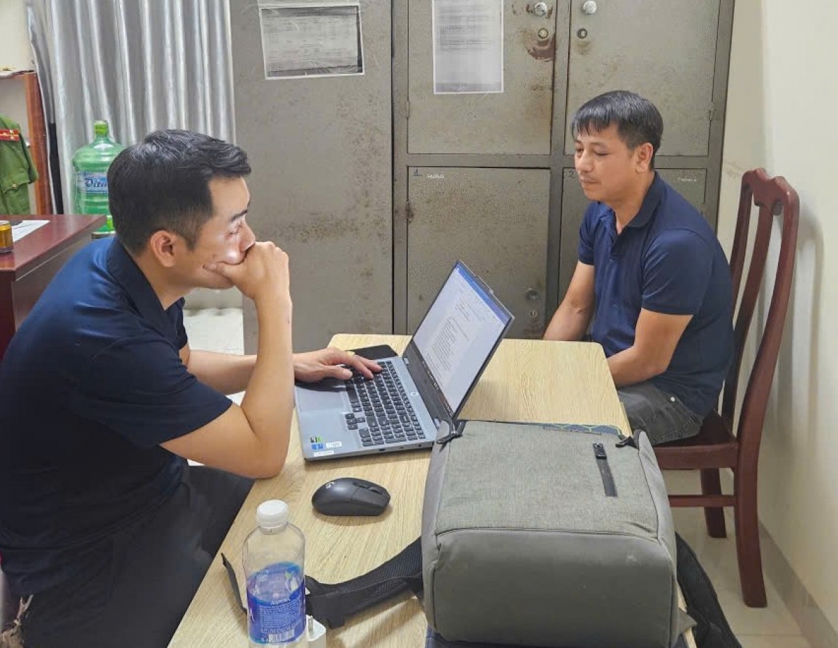 Cơ quan điều tra lấy lời khai Đỗ Công Khuê (bên phải)