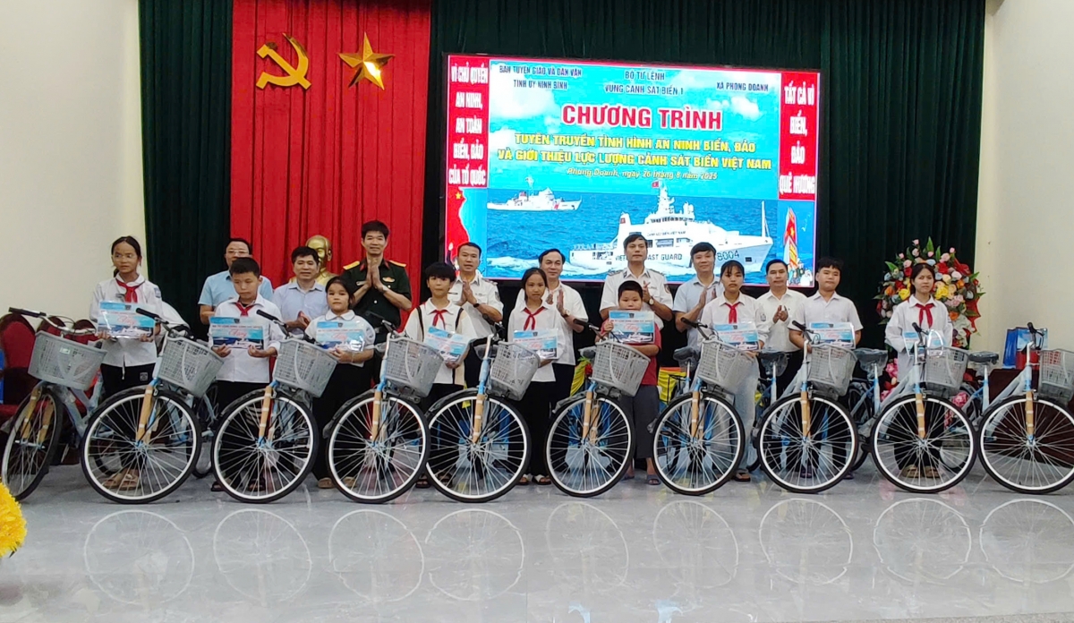   Các đại biểu tặng xe đạp cho các cháu học sinh vượt khó vươn lên trong học tập của xã Phong Doanh