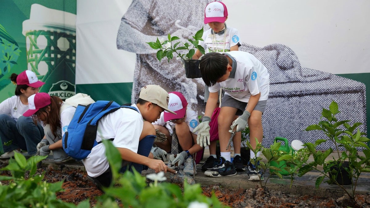 Các em học sinh được hướng dẫn trồng cây xanh