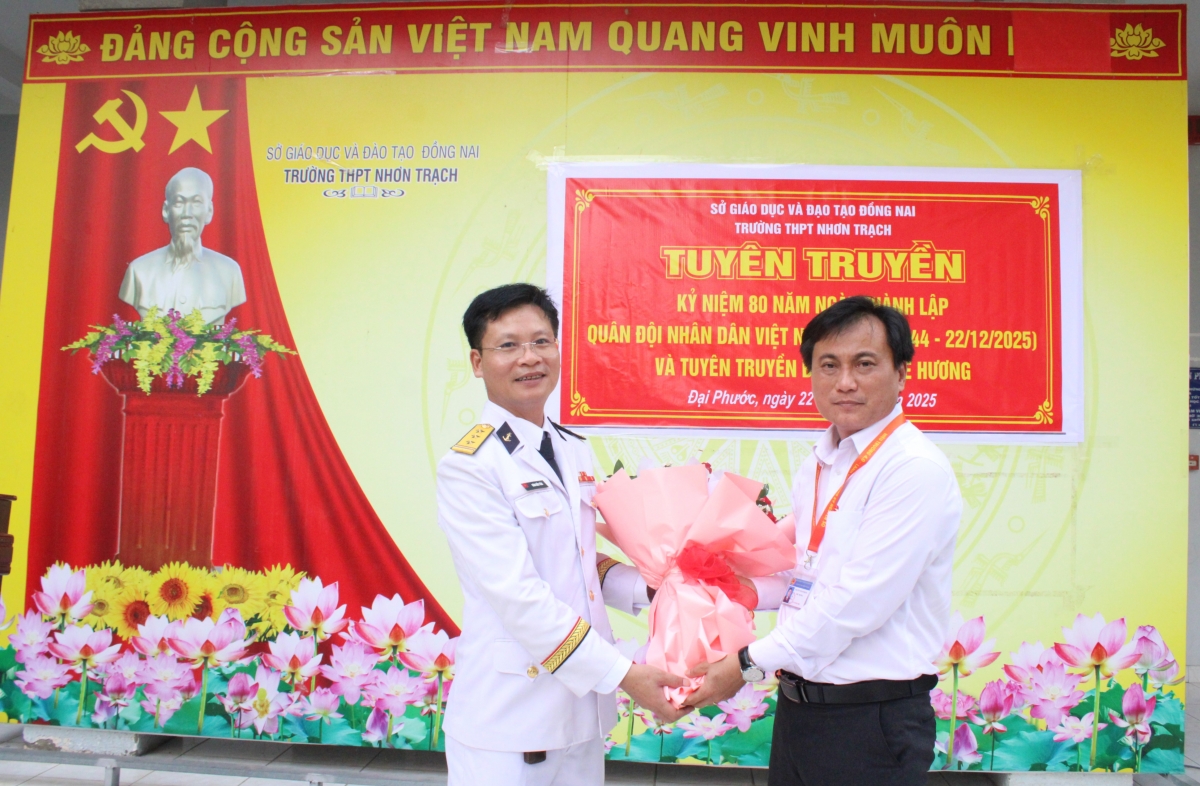 Thầy giáo Nguyễn Thanh Bằng, Hiệu trưởng Trường THPT Nhơn Trạch tặng hoa chúc mừng