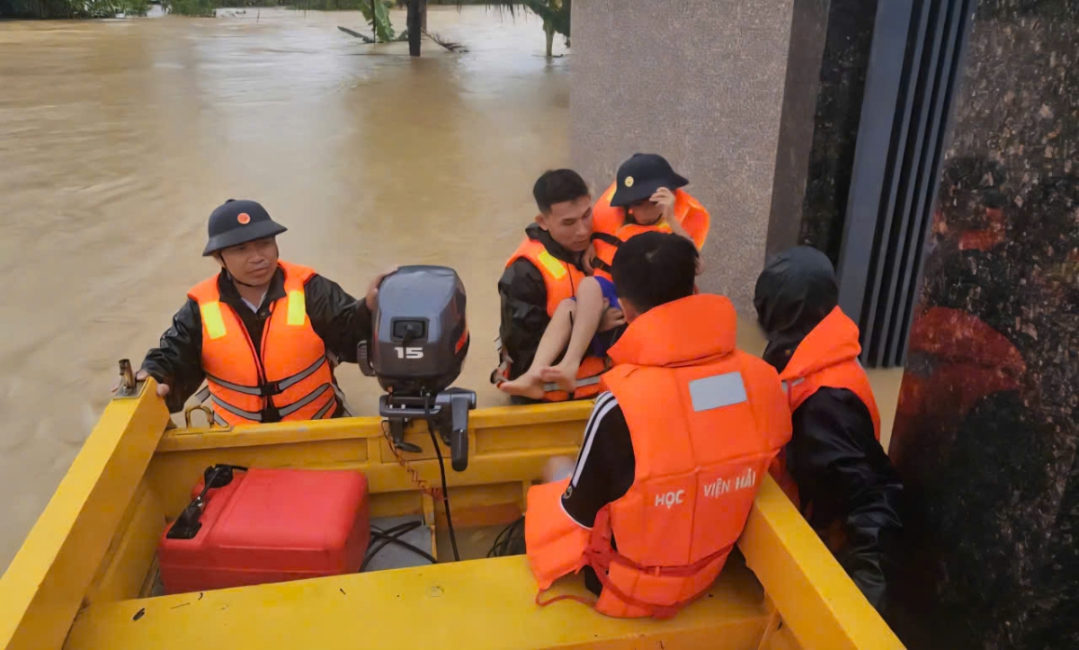 Kíp xuồng và đồng chí Tứ đưa người dân từ khu vực bị nước lũ chia cắt đến khu vực an toàn