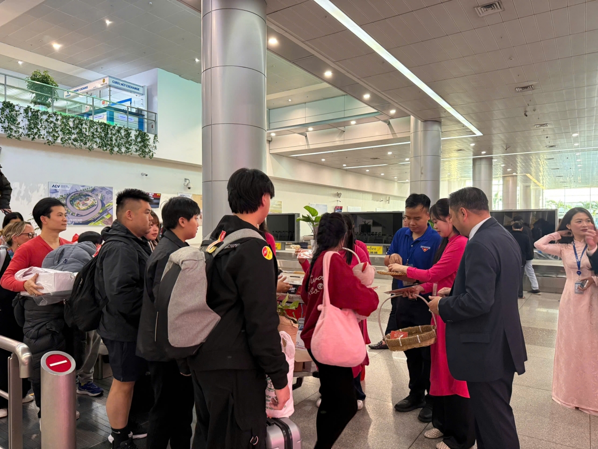 Đại diện lãnh đạo Sở Du lịch TP.HCM đón và tặng quà cho du khách tại Cảng Hàng không quốc tế Tân Sơn Nhất sáng ngày 1-1-2025 (Ảnh: T.H)