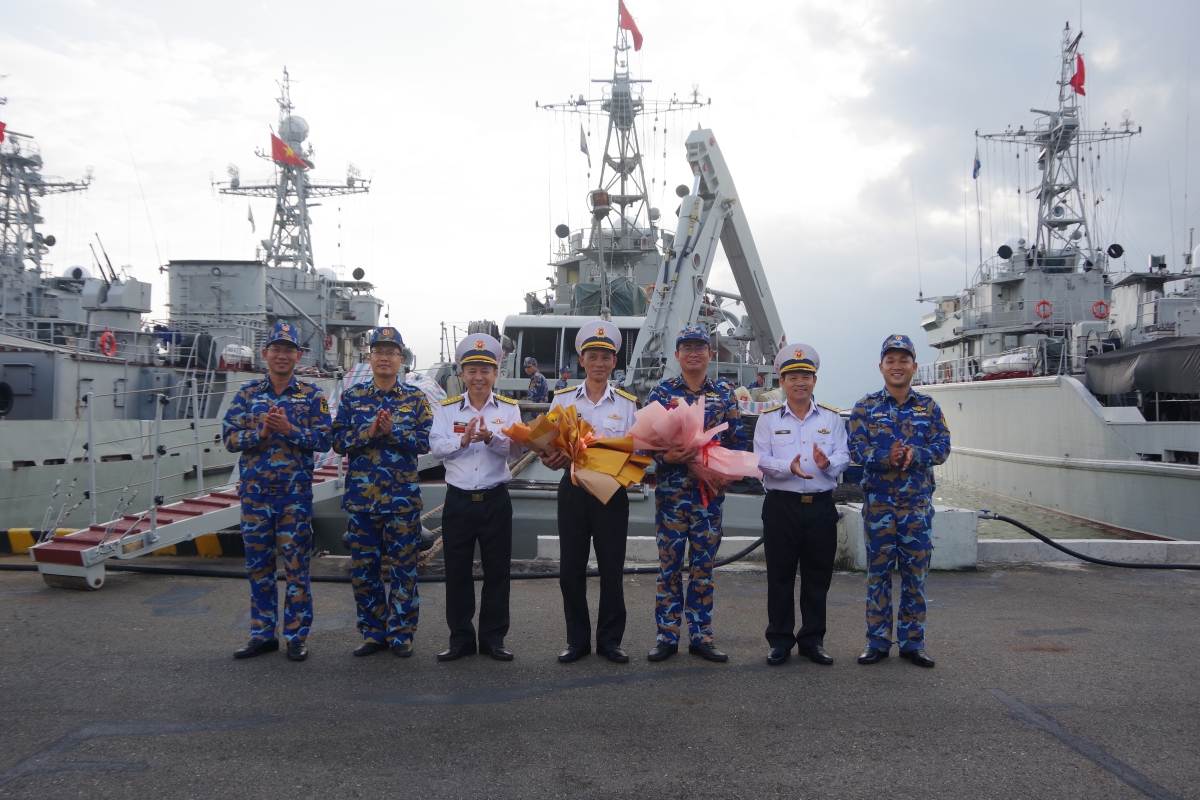 Đại tá Nguyễn Văn Tư - Lữ đoàn trưởng, Lữ đoàn 161, Vùng 3 Hải quân (thứ 3 từ bên trái sang) tặng hoa chúc mừng Tàu thực hiện tốt nhiệm vụ.