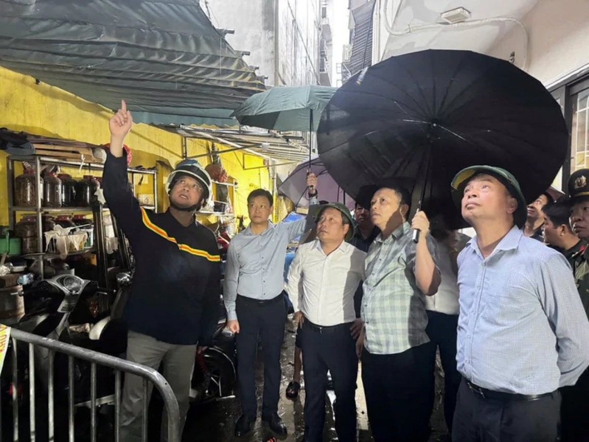 Chủ tịch UBND thành phố Hà Nội Vũ Đại Thắng (đứng giữa) có mặt tại hiện trường vụ cháy sáng sớm nay - Ảnh: HỒNG QUANG